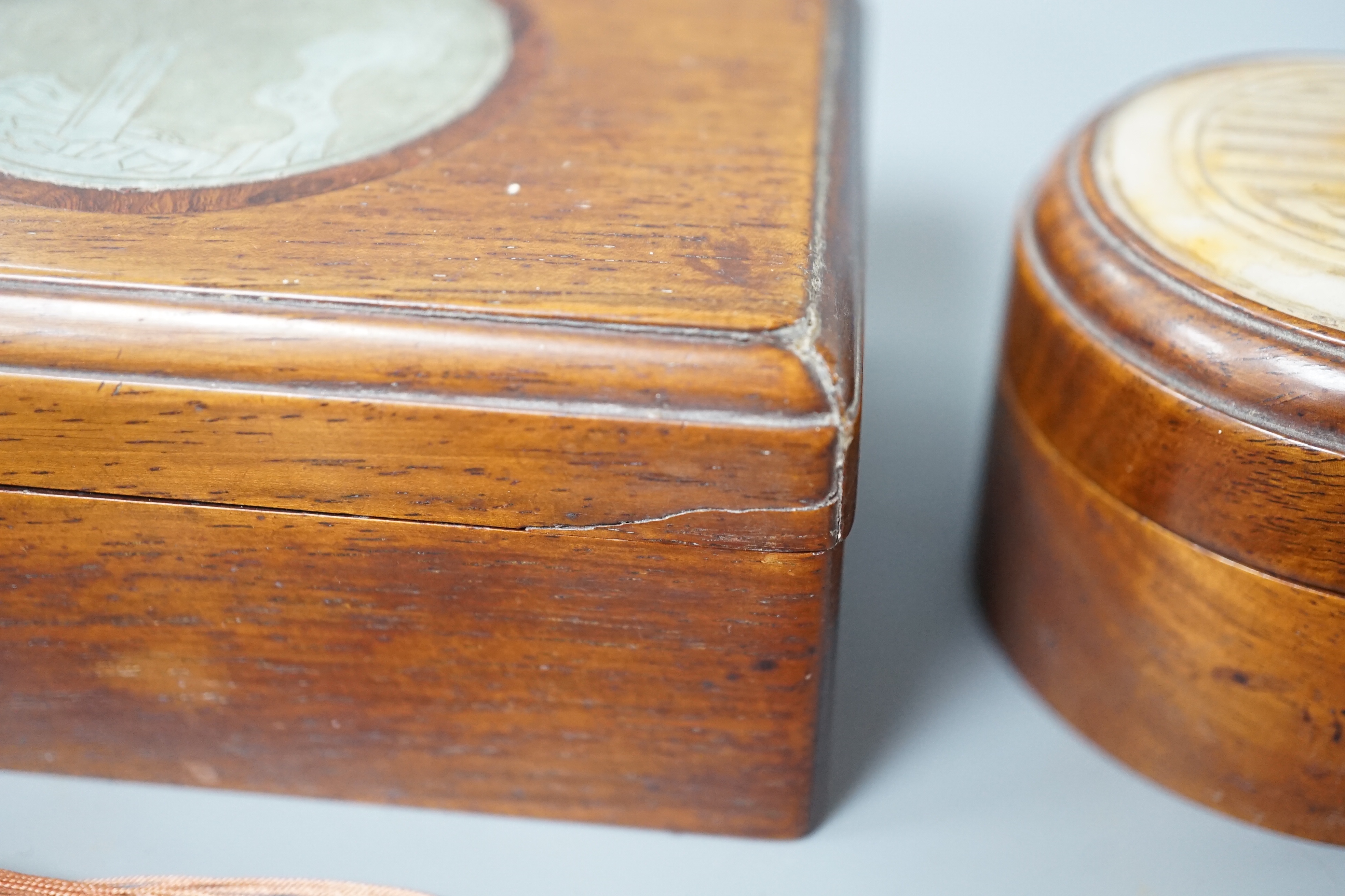 Two 19th century Chinese hardstone inset hardwood boxes and an embroidered amulet charm, largest box 12.5cm